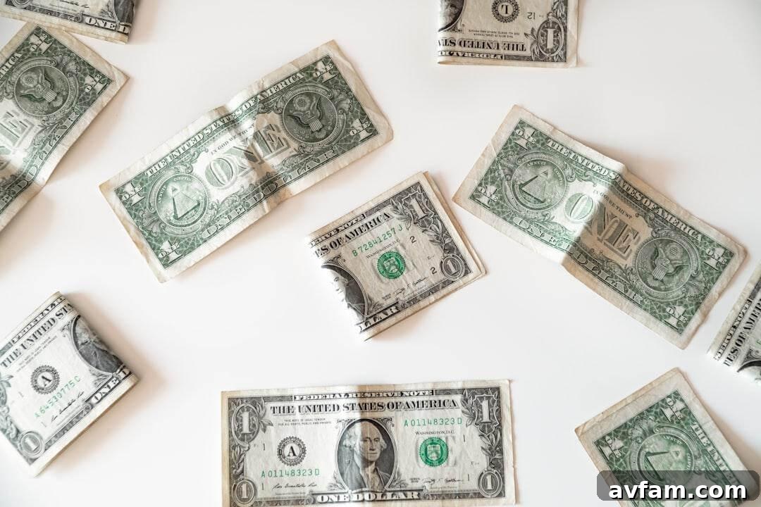 Several US one-dollar bills scattered across a plain white background