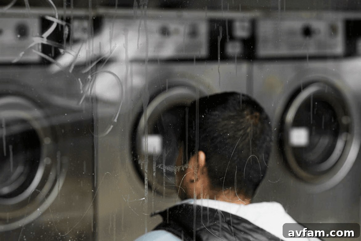 Man examining a row of washing machines