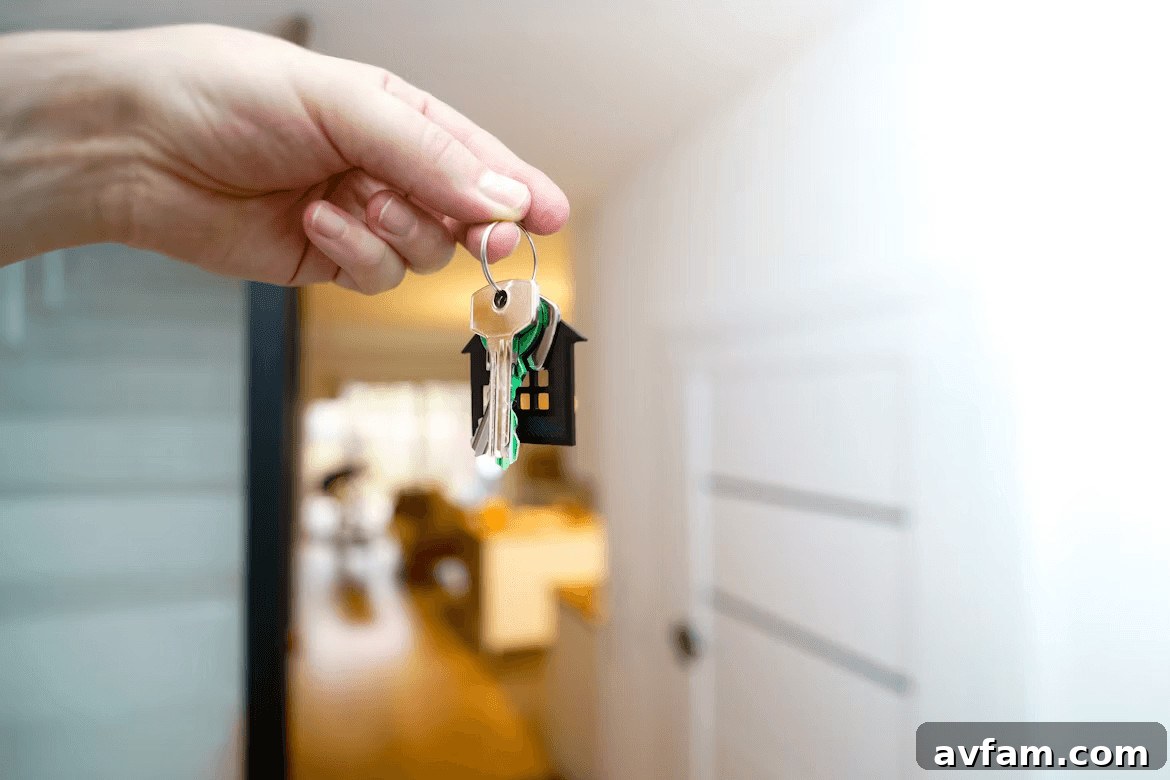 Hand holding a house-shaped key chain,