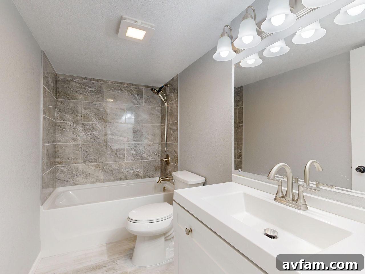 modern bathroom with sink, toilet, and bathtub